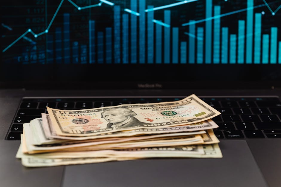 Money and analytics workspace representing faceless YouTube revenue stack
