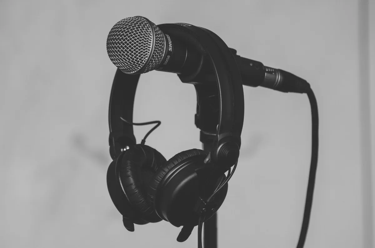 Close-up of a professional microphone and headphones on a studio stand