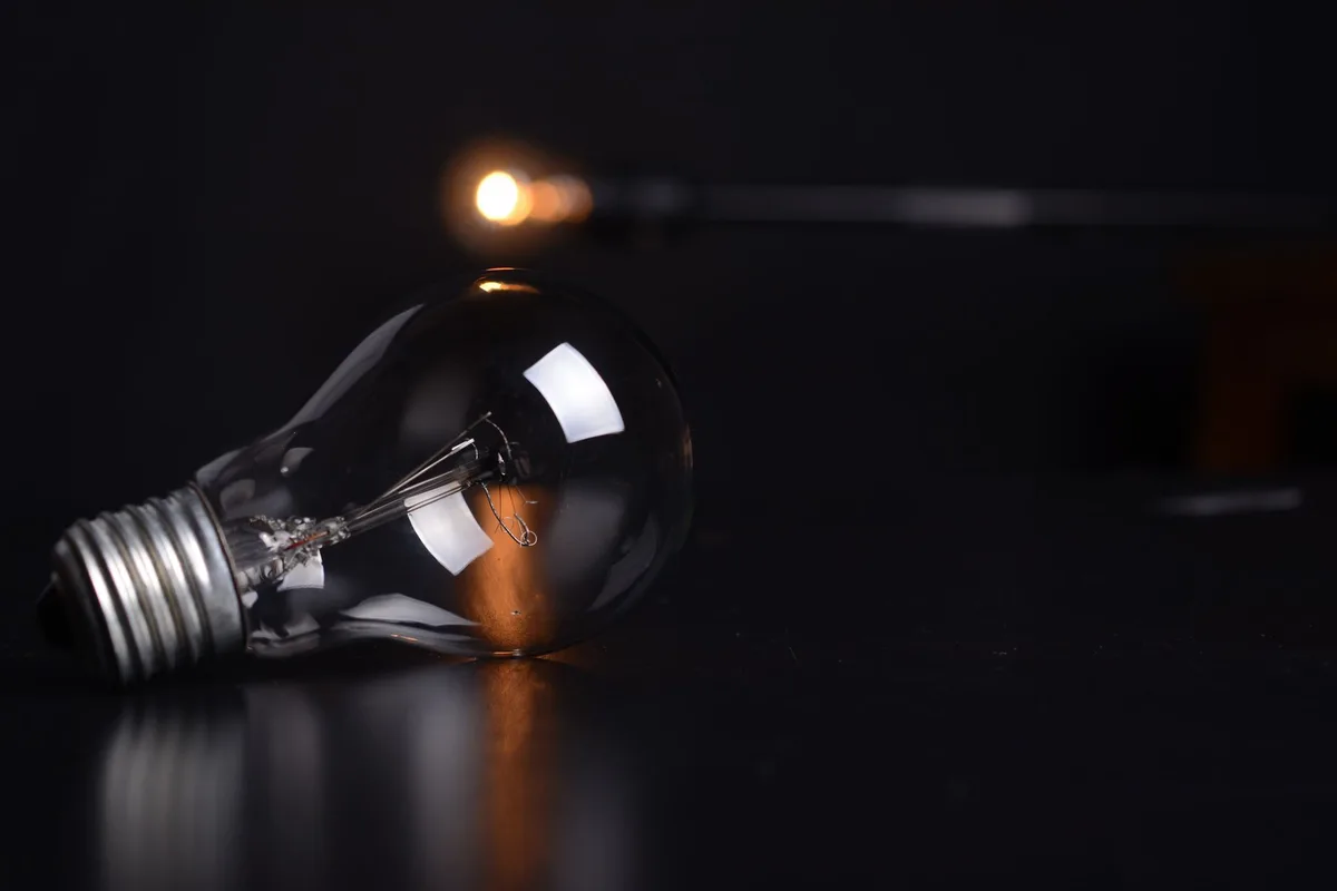 A reflective light bulb on a dark background representing bright ideas and curiosity for trivia and fun facts content