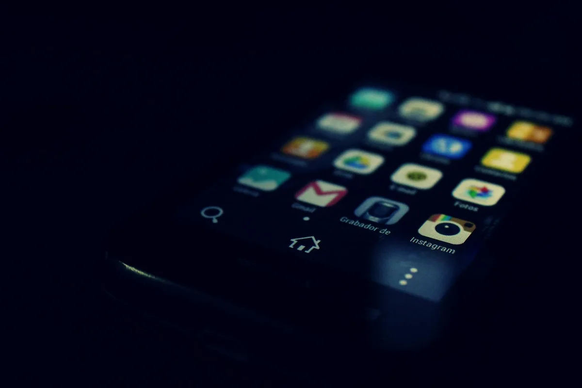 Abstract phone outline with content grid icons on dark charcoal background