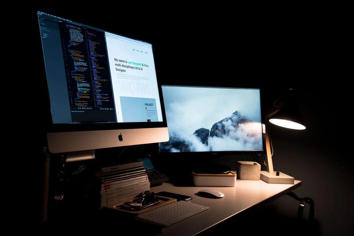 Clean dual-monitor workspace setup representing a professional tech content creation environment