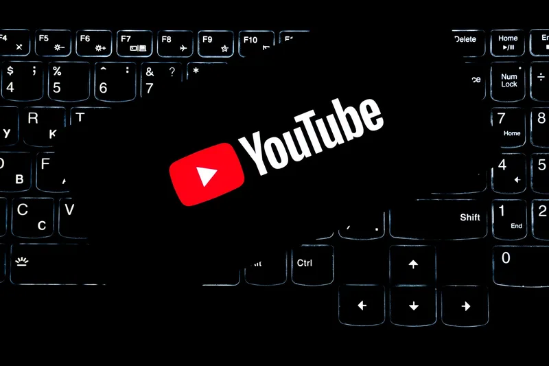 YouTube logo on keyboard representing online content creation and channel earnings