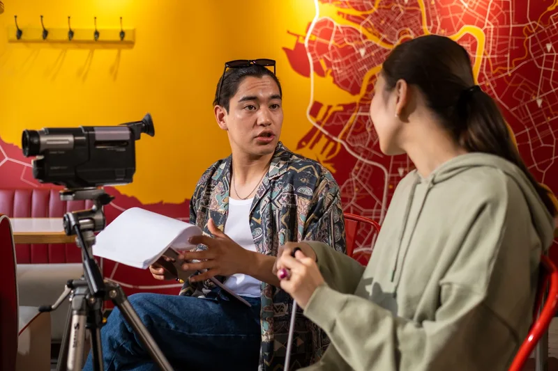 Young filmmakers planning shots during a video production session