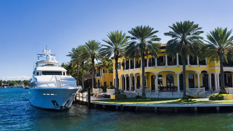 Luxury yacht at a waterfront mansion